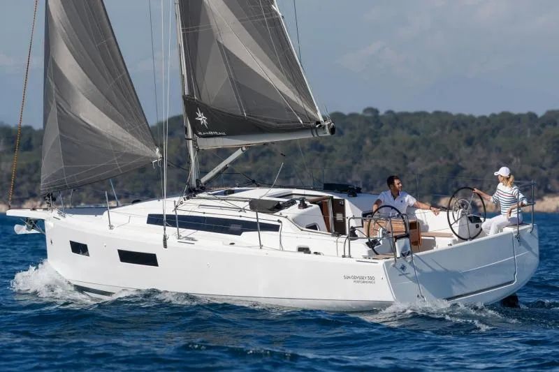 C'est Chic Yacht Photos Pics Manufacturer Provided Image: 2025 Jeanneau Sun Odyssey 350 sailing on open water with two people onboard.