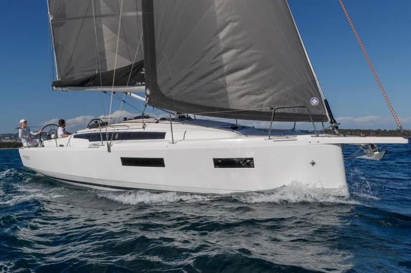 C'est Chic Yacht Photos Pics Manufacturer Provided Image: 2025 Jeanneau Sun Odyssey 350 sailing on open water, sleek design, white hull, black sails.