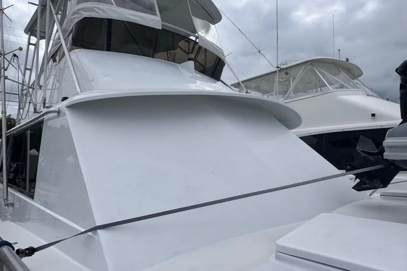  Yacht Photos Pics 1979 Hatteras 53 Motor Yacht, white exterior, docked under cloudy skies.