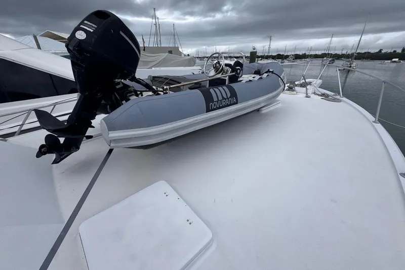  Yacht Photos Pics 1979 Hatteras 53 Motor Yacht with Novurania tender on deck, moored in a marina.