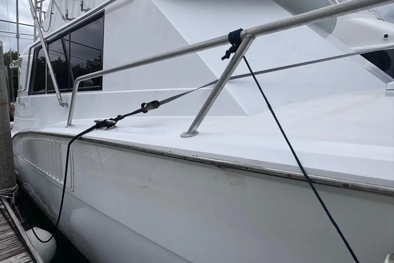  Yacht Photos Pics 1979 Hatteras 53 Motor Yacht docked, showcasing sleek white exterior and railing details.