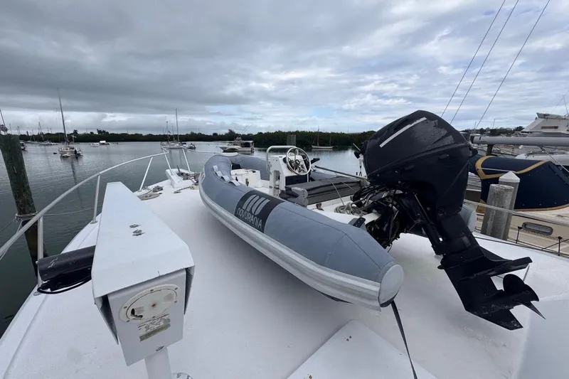  Yacht Photos Pics 1979 Hatteras 53 Motor Yacht with inflatable boat on deck, docked in a marina.