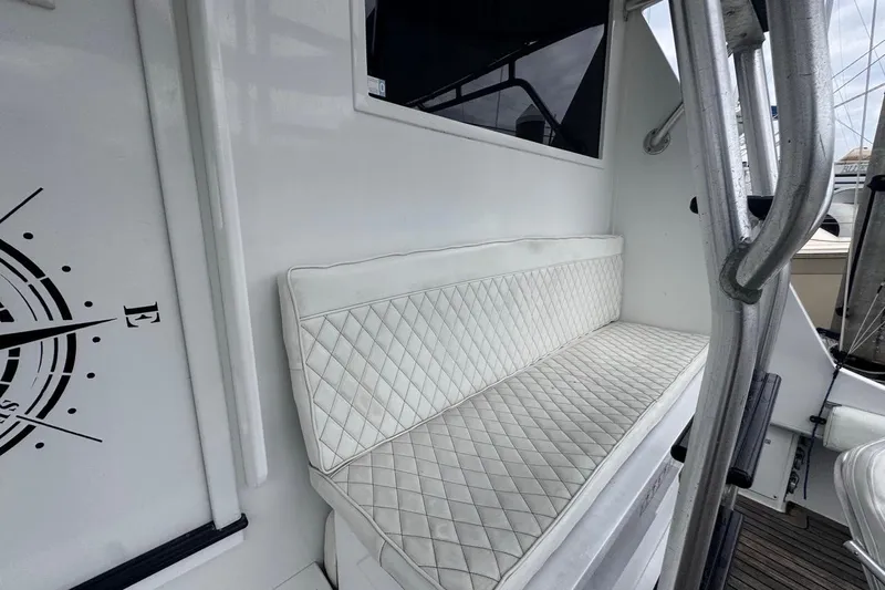  Yacht Photos Pics White cushioned seating on 1979 Hatteras 53 Motor Yacht, featuring quilted design and nautical decor.