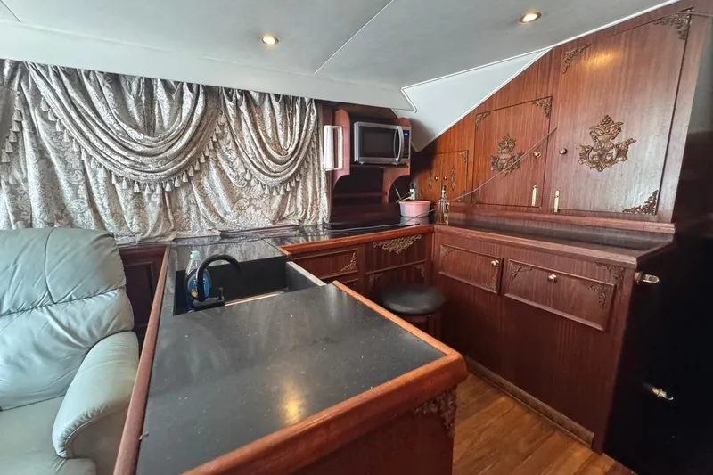  Yacht Photos Pics Luxurious interior of a 1979 Hatteras 53 Motor Yacht with elegant wood cabinetry.