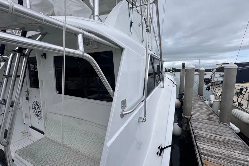  Yacht Photos Pics 1979 Hatteras 53 Motor Yacht docked at marina, side view with ladder and seating.