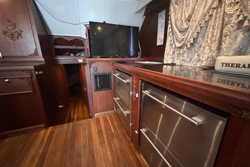  Yacht Photos Pics Interior of 1979 Hatteras 53 Motor Yacht with wood paneling and modern appliances.