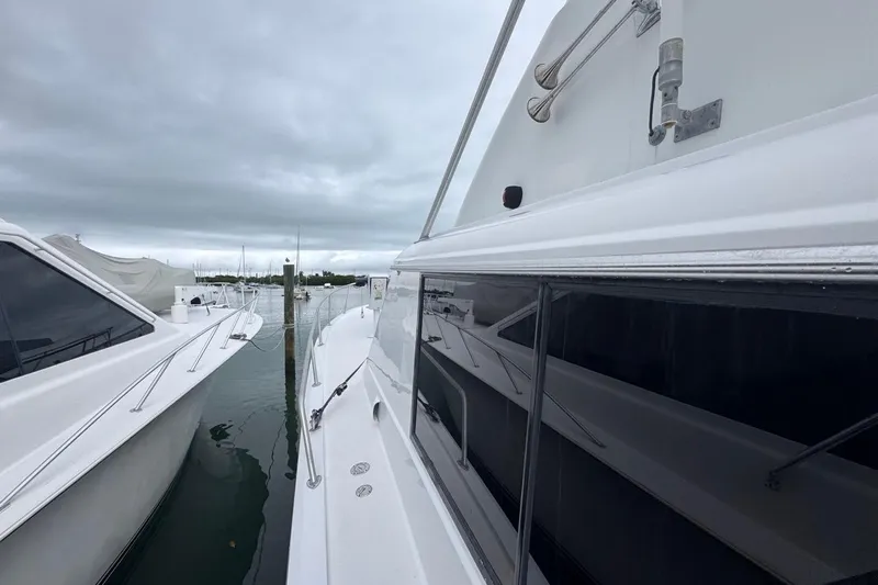  Yacht Photos Pics 1979 Hatteras 53 Motor Yacht docked, showcasing sleek design and spacious deck.