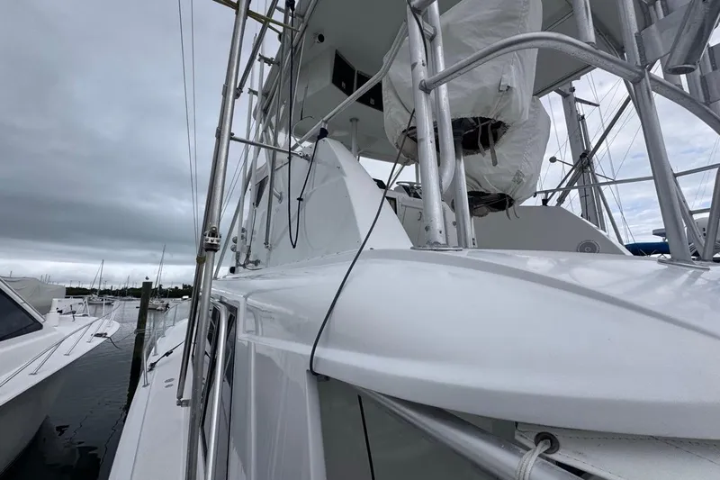  Yacht Photos Pics 1979 Hatteras 53 Motor Yacht docked under cloudy skies, showcasing sleek design and structure.