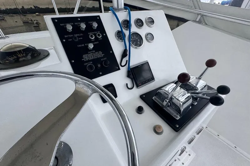  Yacht Photos Pics Control panel of a 1979 Hatteras 53 Motor Yacht with steering wheel and throttle levers.