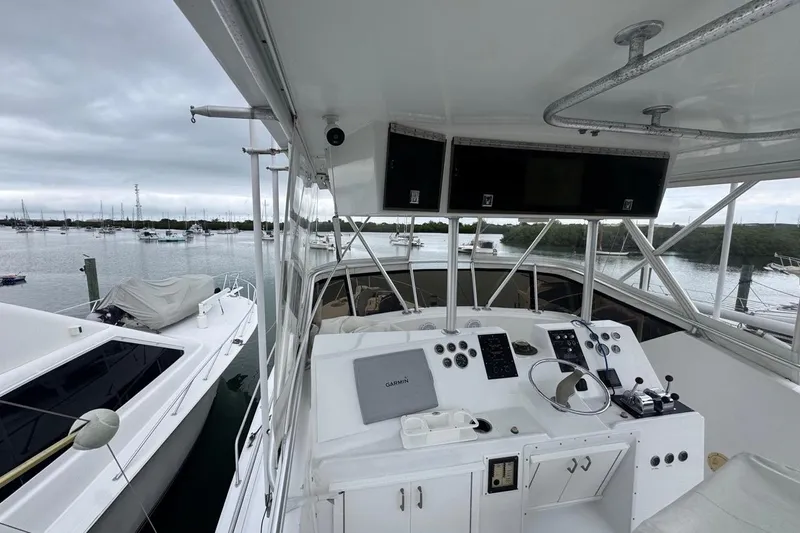  Yacht Photos Pics 1979 Hatteras 53 Motor Yacht helm with marina view, overcast sky.