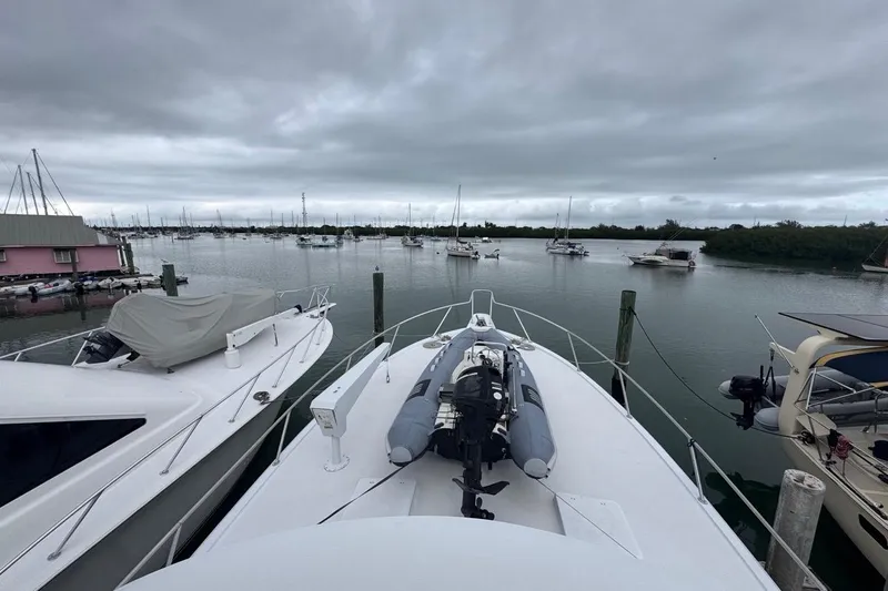  Yacht Photos Pics 1979 Hatteras 53 Motor Yacht docked in a marina under cloudy skies.