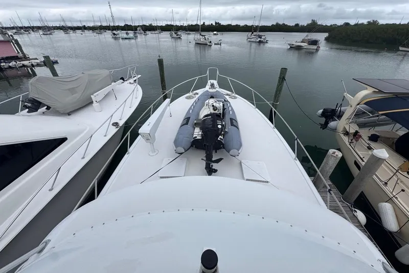  Yacht Photos Pics 1979 Hatteras 53 Motor Yacht docked with inflatable boat on deck.