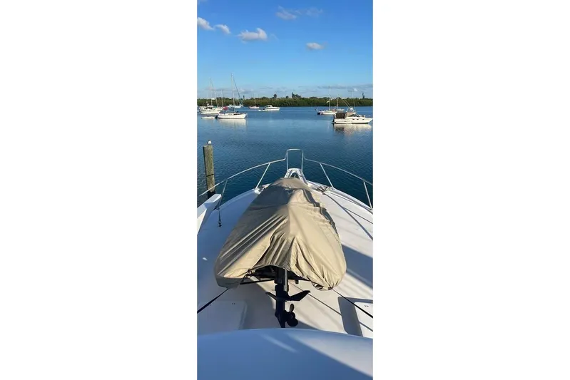  Yacht Photos Pics 1979 Hatteras Sportfish 53' yacht bow view in serene marina setting.