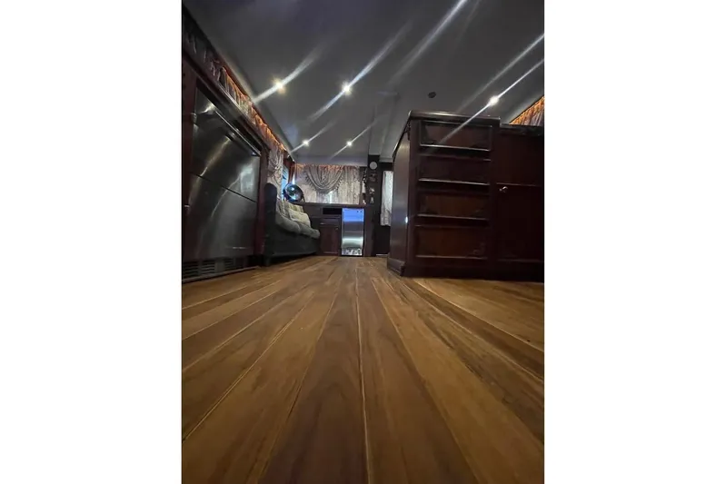  Yacht Photos Pics Interior of 1979 Hatteras Sportfish 53' yacht with wooden flooring and elegant furnishings.