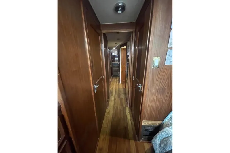  Yacht Photos Pics Interior hallway of 1979 Hatteras Sportfish 53' yacht with wooden paneling.