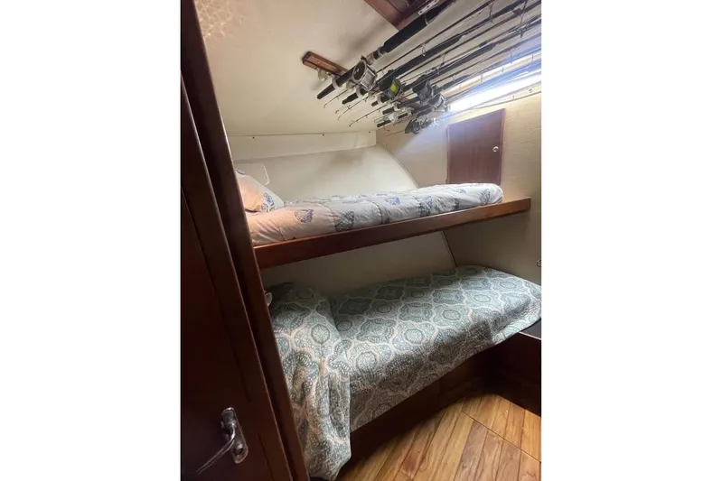  Yacht Photos Pics 1979 Hatteras Sportfish 53' cabin with bunk beds and fishing rods.