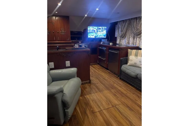  Yacht Photos Pics Luxurious interior of 1979 Hatteras Sportfish 53' yacht with wood paneling and comfortable seating.