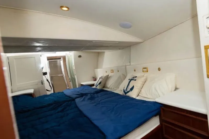  Yacht Photos Pics Interior cabin of 1979 Hatteras Sportfish 53' yacht with nautical-themed bedding.