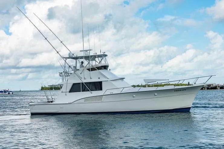  Yacht Photos Pics 1979 Hatteras Sportfish 53' yacht on calm water under a cloudy sky.
