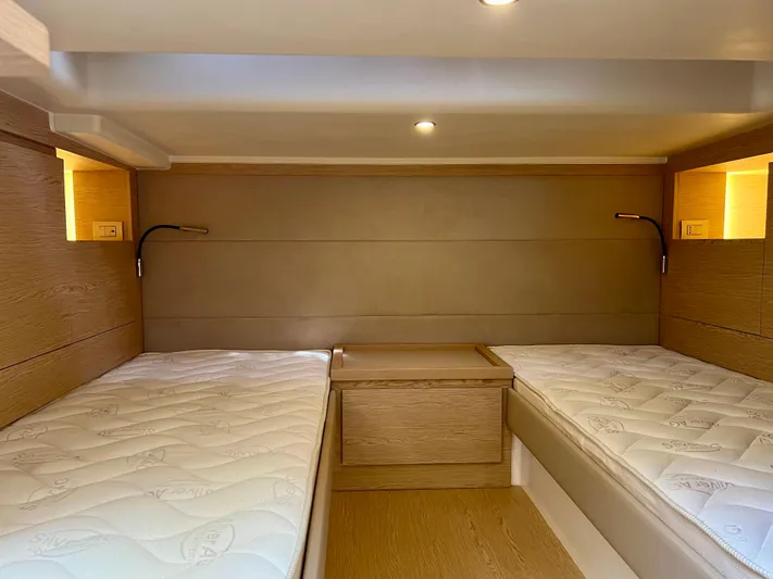  Yacht Photos Pics 2024 Solaris Power 44 Open cabin with twin beds and modern wooden interior.