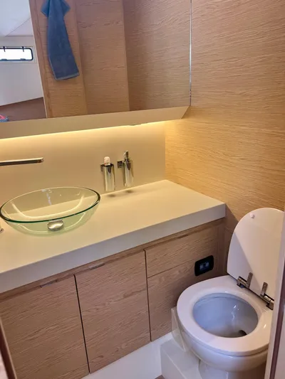 Yacht Photos Pics 2024 Solaris Power 44 Open yacht bathroom with modern fixtures and glass sink.