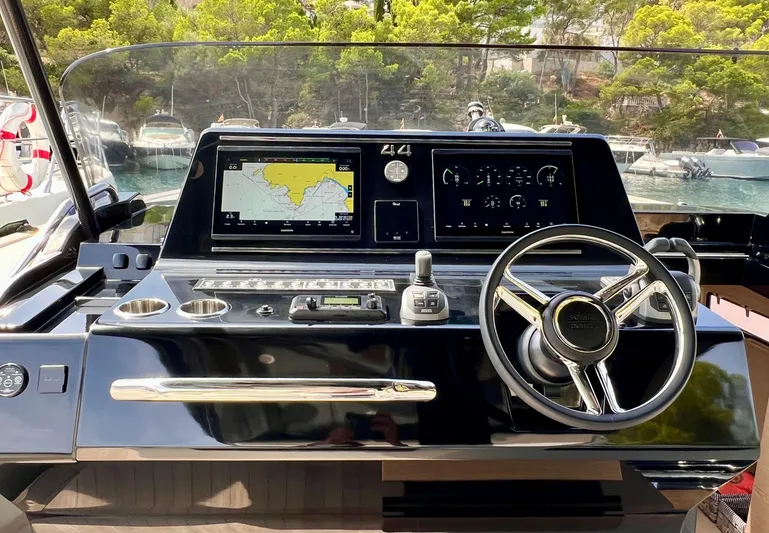  Yacht Photos Pics 2024 Solaris Power 44 Open helm with navigation display and steering wheel.