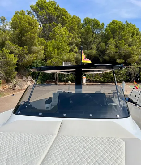  Yacht Photos Pics 2024 Solaris Power 44 Open yacht with sleek design, docked near lush greenery.