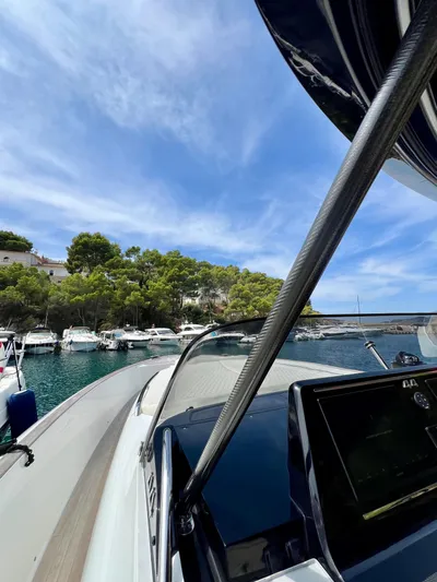  Yacht Photos Pics 2024 Solaris Power 44 Open yacht docked in a scenic marina under a clear blue sky.