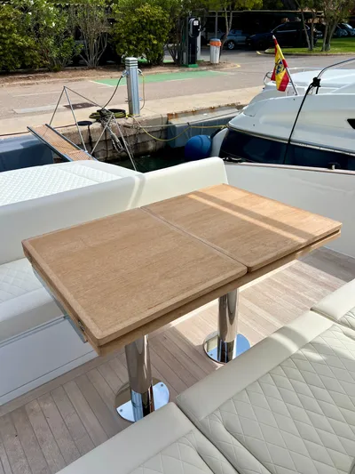  Yacht Photos Pics 2024 Solaris Power 44 Open yacht with elegant outdoor seating and wooden table.