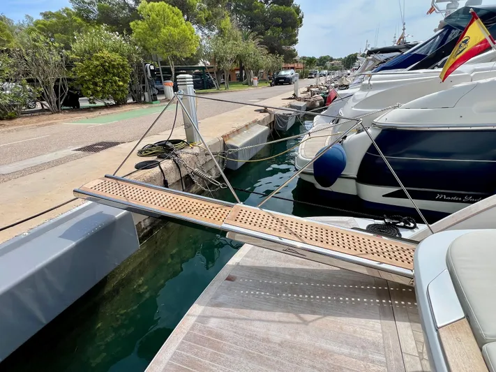  Yacht Photos Pics 2024 Solaris Power 44 Open yacht docked with a wooden gangway.