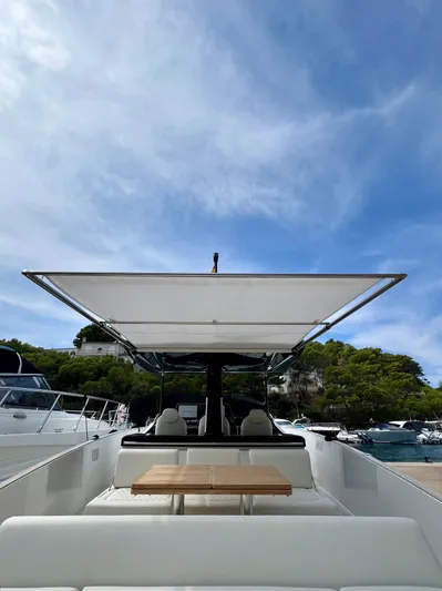  Yacht Photos Pics 2024 Solaris Power 44 Open yacht with sleek design and spacious deck under a clear blue sky.