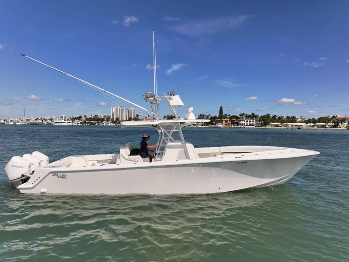  Yacht Photos Pics 2020 SeaVee 370z boat cruising on a sunny day in coastal waters.
