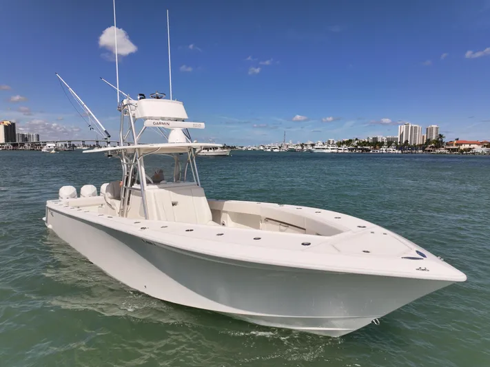  Yacht Photos Pics 2020 SeaVee 370z boat on clear water with city skyline in background.