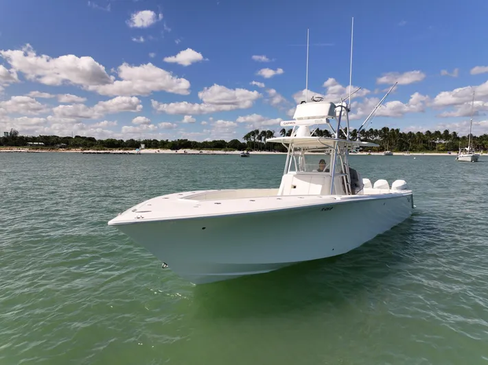  Yacht Photos Pics 2020 SeaVee 370z boat on calm water under a blue sky with clouds.