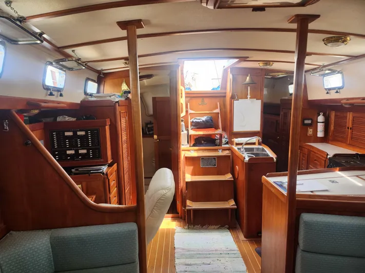 Sensation Yacht Photos Pics Interior of a 1998 Tartan 4100 sailboat with wood finish and compact kitchen.