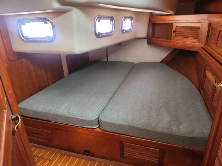 Sensation Yacht Photos Pics Cozy cabin interior of 1998 Tartan 4100 sailboat with twin beds and wooden cabinetry.