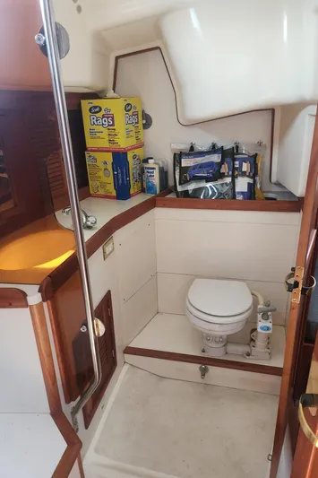 Sensation Yacht Photos Pics 1998 Tartan 4100 yacht bathroom with toilet and cleaning supplies.
