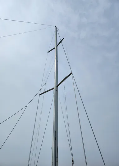 Sensation Yacht Photos Pics Mast of a 1998 Tartan 4100 sailboat against a cloudy sky.