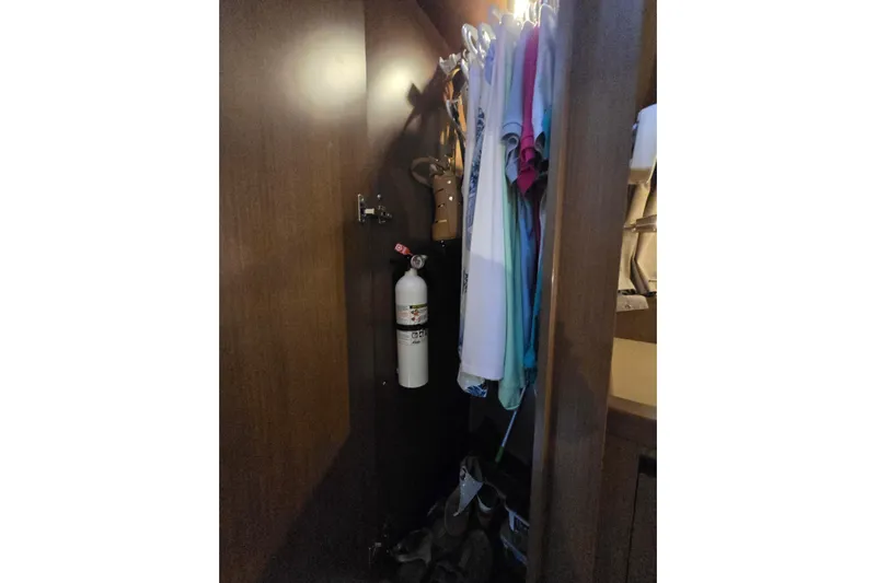 Tiger "times" 2 Yacht Photos Pics Closet interior on 2017 Sea Ray Sundancer 400 with clothes and fire extinguisher.