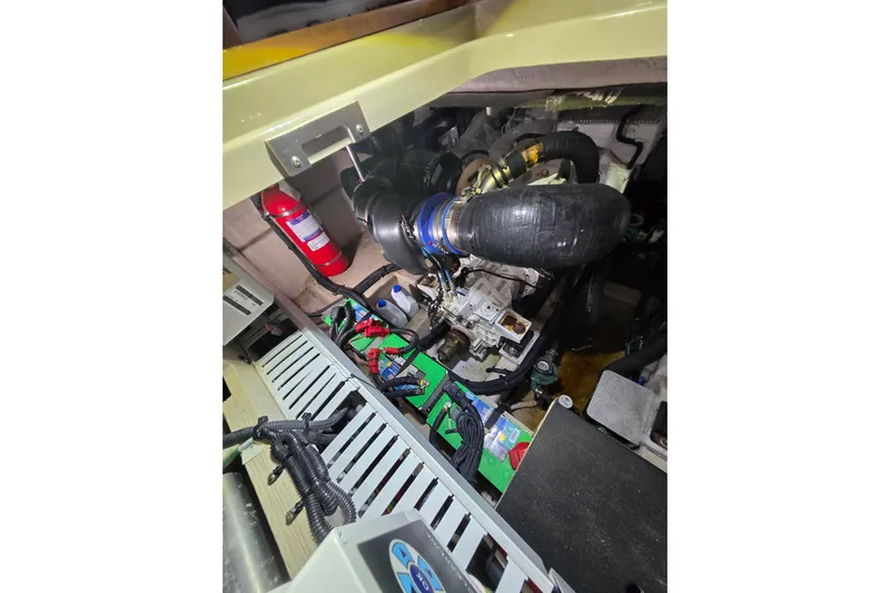 Tiger "times" 2 Yacht Photos Pics Engine compartment of 2017 Sea Ray Sundancer 400 with visible components and fire extinguisher.