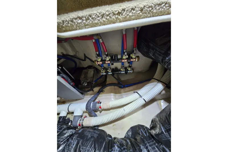 Tiger "times" 2 Yacht Photos Pics Engine compartment of 2017 Sea Ray Sundancer 400 with visible plumbing and wiring.