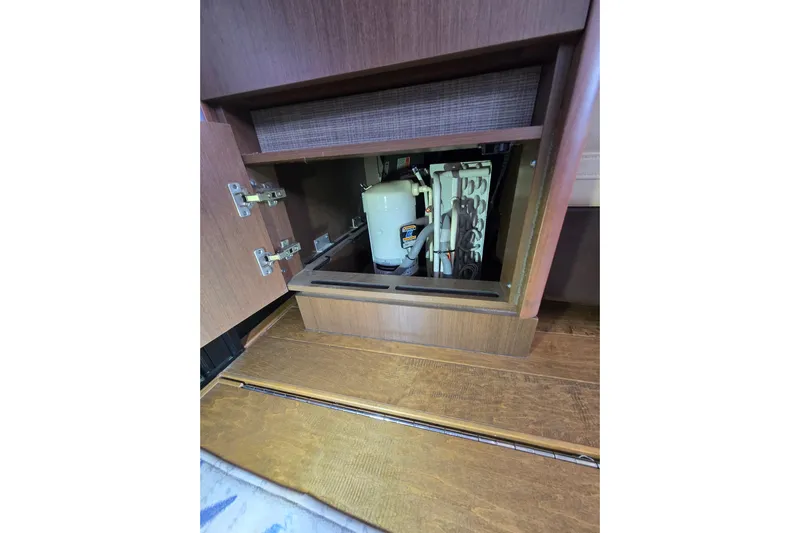 Tiger "times" 2 Yacht Photos Pics 2017 Sea Ray Sundancer 400 interior cabinet with open door revealing equipment.