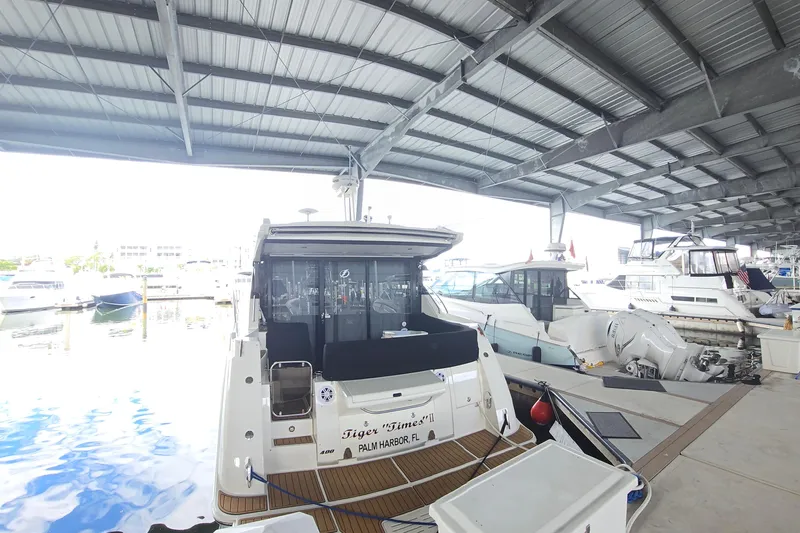 Tiger "times" 2 Yacht Photos Pics 2017 Sea Ray Sundancer 400 yacht docked in a marina under a metal roof.