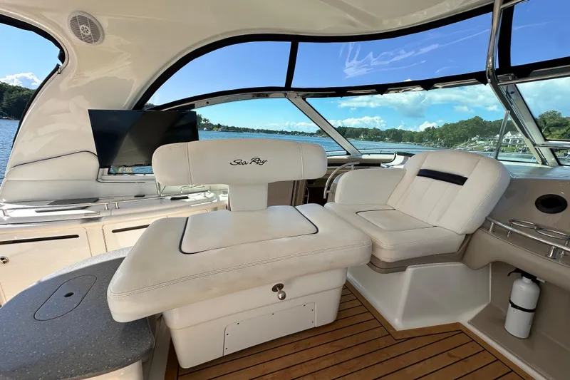 Apres Sea Yacht Photos Pics Luxurious interior of 2006 Sea Ray 52 Sundancer yacht with plush seating and scenic view.