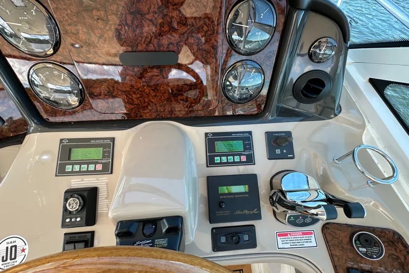 Apres Sea Yacht Photos Pics Control panel of a 2006 Sea Ray 52 Sundancer yacht with gauges and navigation controls.