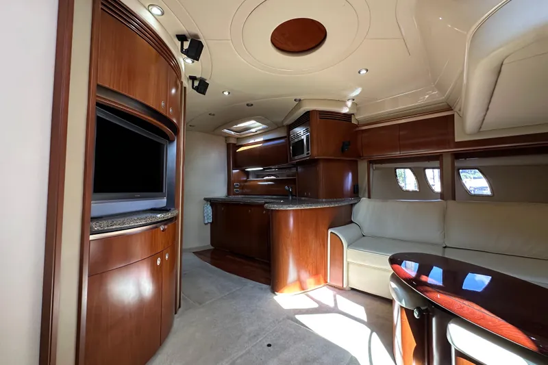 Apres Sea Yacht Photos Pics Luxurious interior of 2006 Sea Ray 52 Sundancer yacht with modern kitchen and seating area.
