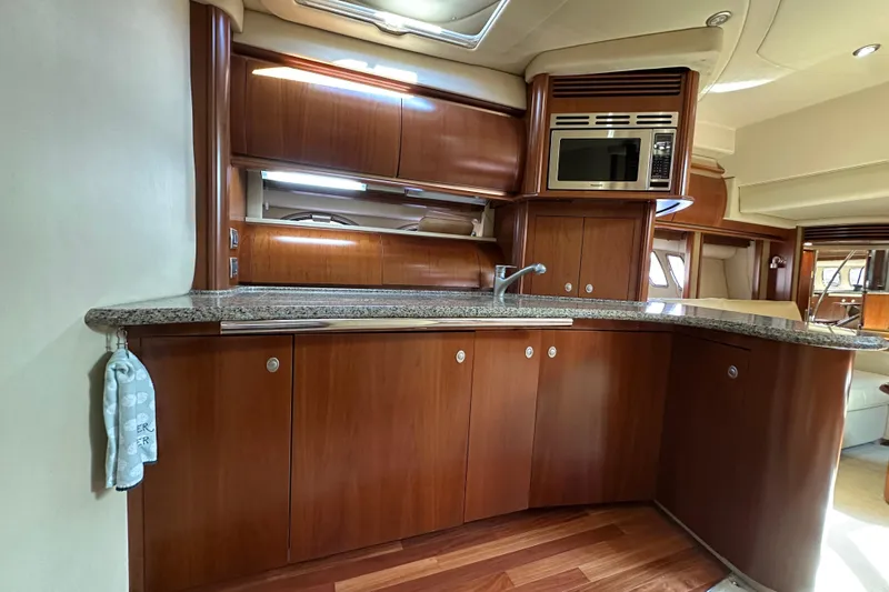 Apres Sea Yacht Photos Pics Luxurious 2006 Sea Ray 52 Sundancer yacht kitchen with wood cabinetry and granite countertops.