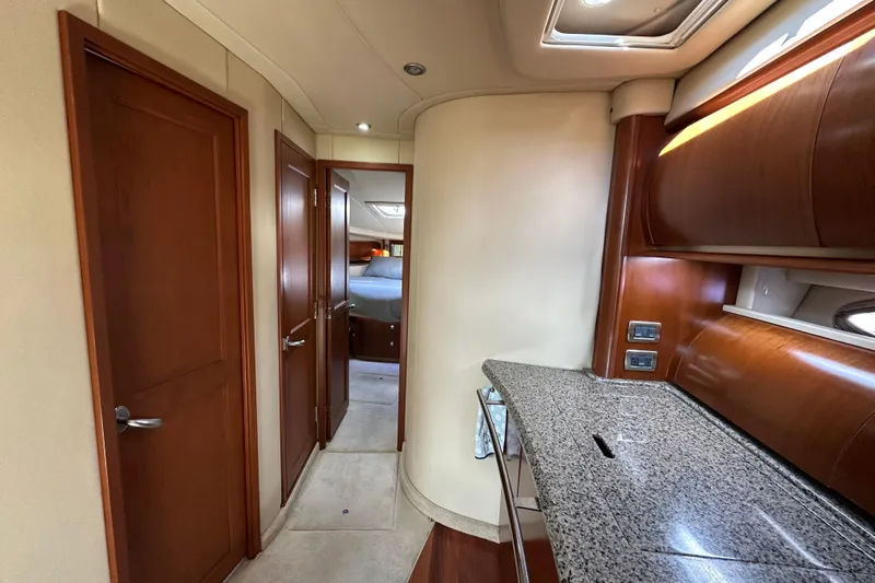Apres Sea Yacht Photos Pics Interior of 2006 Sea Ray 52 Sundancer yacht with wood finishes and granite countertop.