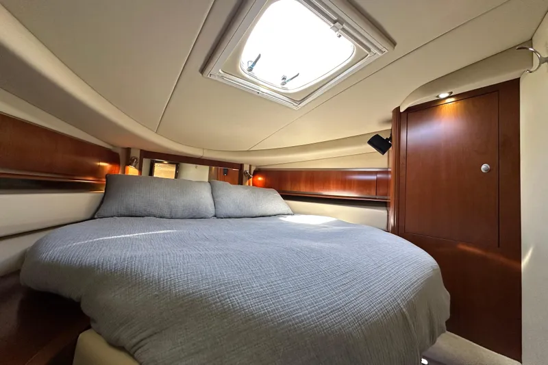 Apres Sea Yacht Photos Pics Luxurious cabin interior of 2006 Sea Ray 52 Sundancer yacht with skylight and wood accents.