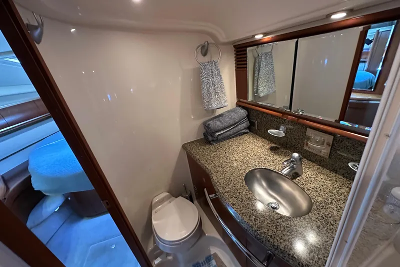 Apres Sea Yacht Photos Pics Luxurious bathroom in 2006 Sea Ray 52 Sundancer yacht with granite countertop and modern fixtures.